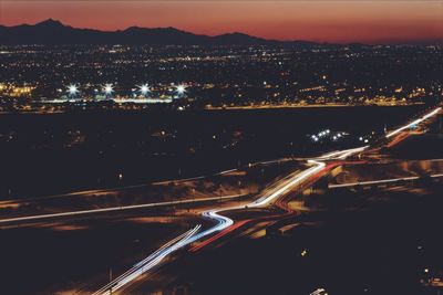 High angle view of illuminated city against sky at night