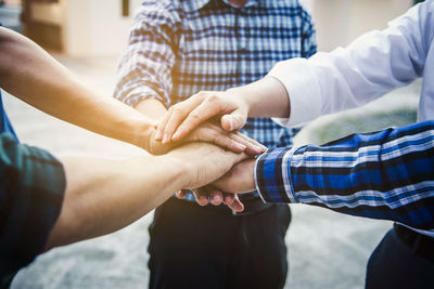 Midsection of couple holding hands