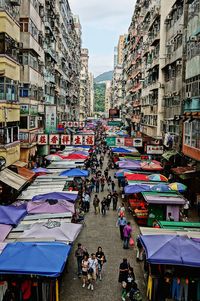 People at market against sky in city