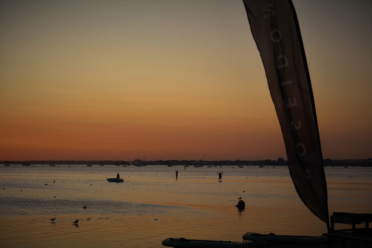 SCENIC VIEW OF SEA AGAINST ORANGE SKY