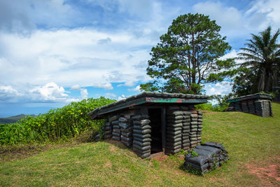 Built structure on field against sky