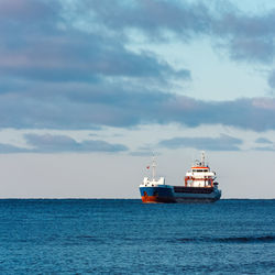 Ship sailing in sea against sky