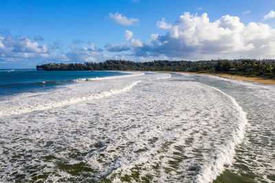 Aerial panoramic image at sunrise off the coast over hanalei bay and waioli beach park on kauai