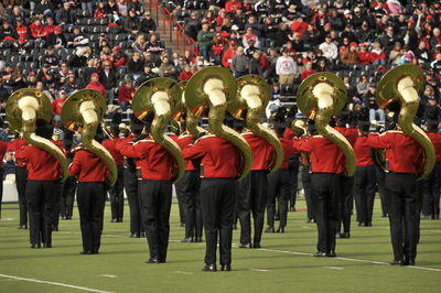 Rear view of musicians standing in stadium