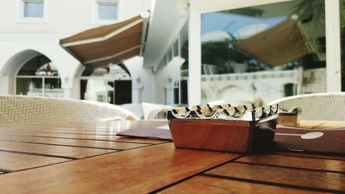 Close-up of ashtray and magazine on table in restaurant