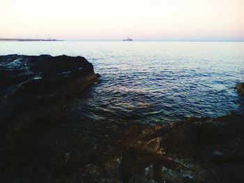 Scenic view of sea against clear sky during sunset