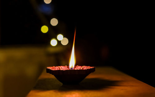 Close-up of illuminated lamp against black background