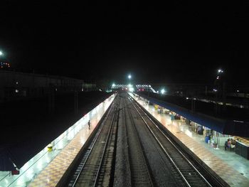 Railroad station against sky at night