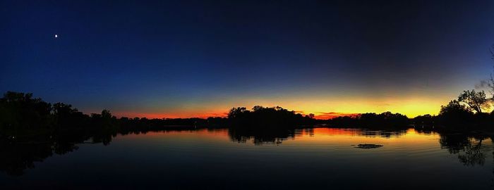 Scenic view of calm lake at sunset