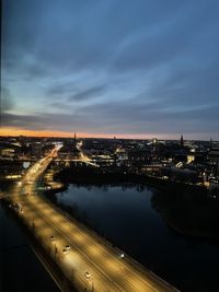 Illuminated cityscape against sky at night