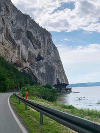 Scenic view of sea and mountains against sky