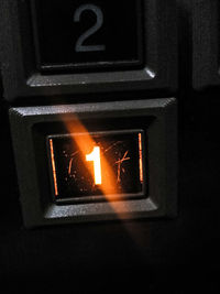 Close-up of illuminated fire sign on wall