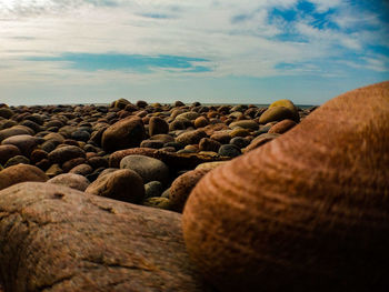 Close-up of stone stack on rock against sky