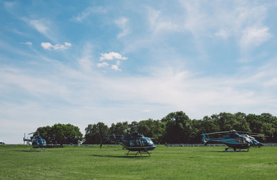 Cars on field against sky