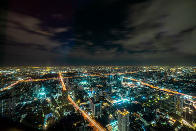High angle view of illuminated buildings in city at night