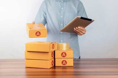 Midsection of woman holding toy blocks on table