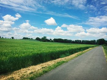 Country road passing through field