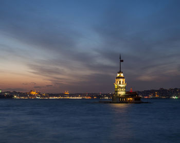 Illuminated buildings in city at waterfront