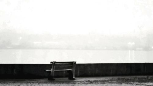 Empty deck chairs against sky