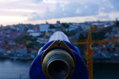 Close-up of coin-operated binoculars against sky