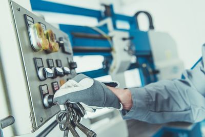 Close-up of man using machinery