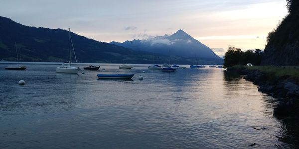 Sailboats in sea against sky