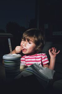 Girl having food in cafe at night