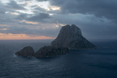 Scenic view of rock formation in sea against sky