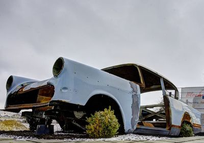 Abandoned airplane on runway against sky