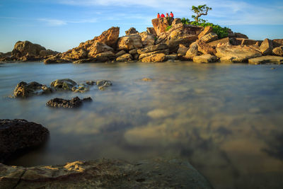 Scenic view of sea and rock formation against sky