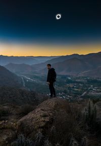 Man standing on mountain against sky