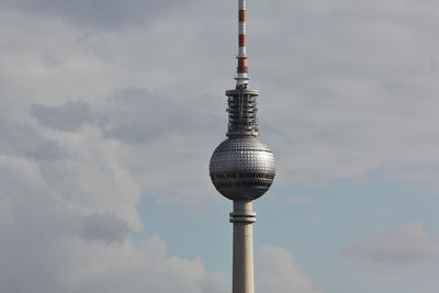 Communications tower against sky in city