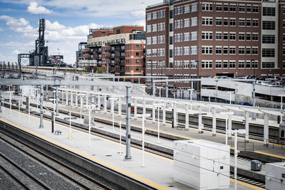 Railroad tracks in city against sky