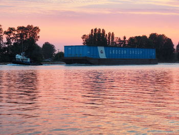 Scenic view of lake against orange sky