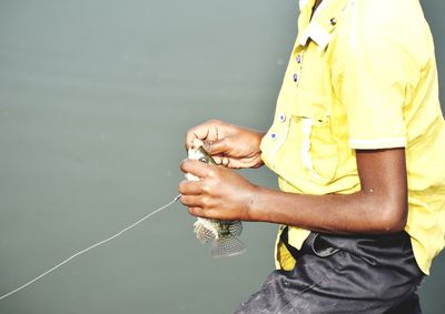 Fishing by a man standing near to river