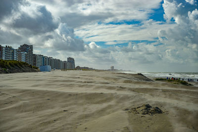 Scenic view of beach against sky in city