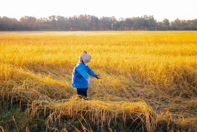 Man standing in field against sky