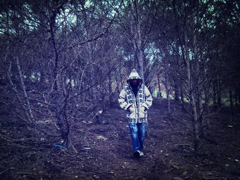 Full length of mature man walking in forest