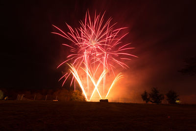 Firework display against sky at night