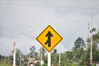 Road sign against clear sky