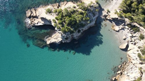 High angle view of rock formation in sea taken from the drone with transparent water