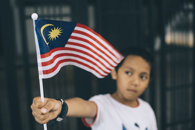 Close-up of man holding flag