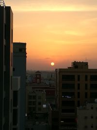 Buildings against sky during sunset
