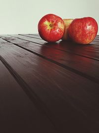 Close-up of red chili peppers on wooden table