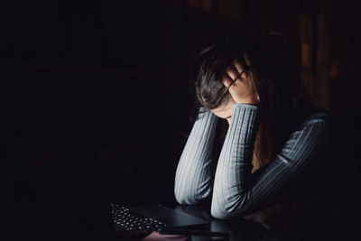 Young woman using laptop at home