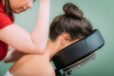 Chair massage in the office. female sitting in her office on a portable massage