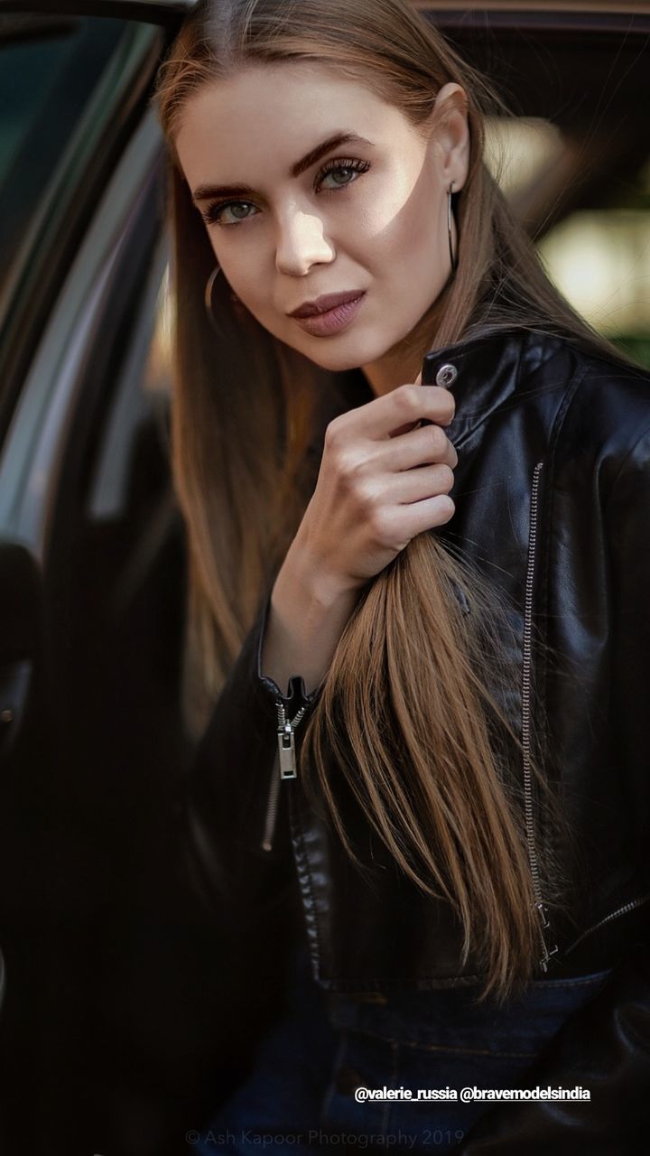 one person, young adult, hair, long hair, young women, beautiful woman, portrait, hairstyle, beauty, lifestyles, real people, women, front view, car, looking at camera, leisure activity, motor vehicle, adult, mode of transportation, fashion, leather