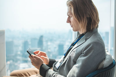 Side view of businessman using mobile phone