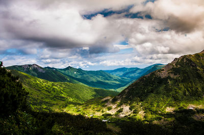 Scenic view of mountains against cloudy sky