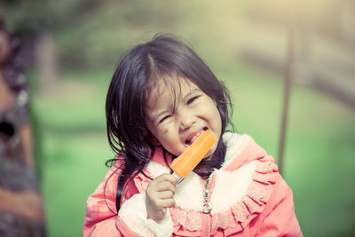 Portrait of cute girl licking ice cream